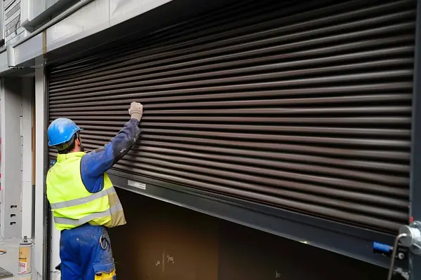 engineer-opening-broken-roller-shutter